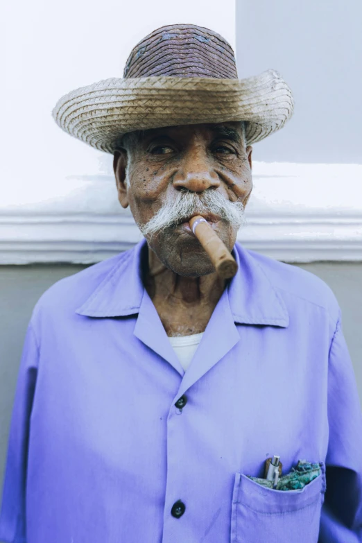 a person wearing a straw hat with a white beard and smoking a cigarette