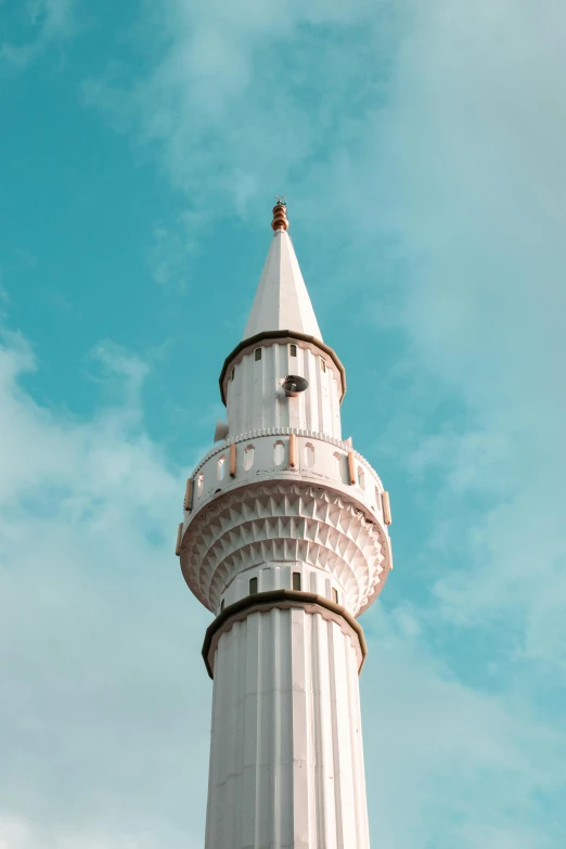 a white lighthouse tower against a blue sky