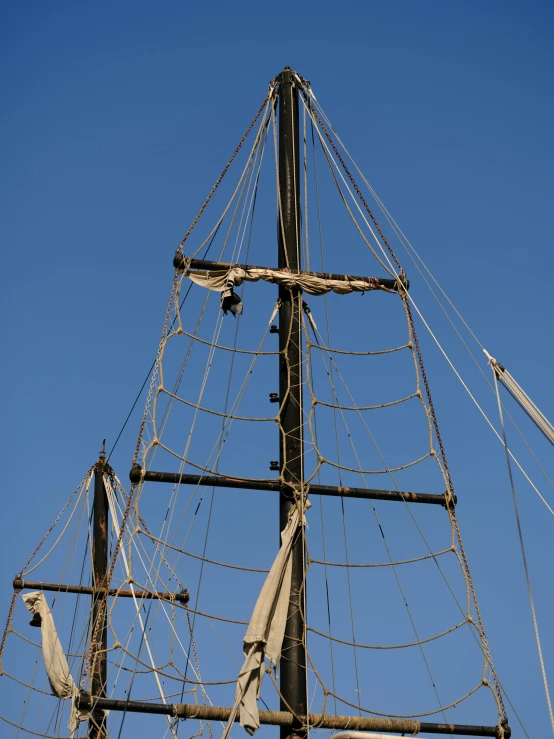 an old wooden boat mast has no ropes