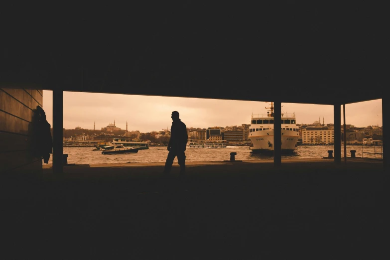 a person standing outside looking out at a harbor