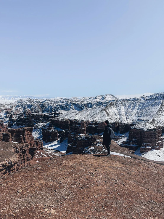 the people are standing on top of a rocky hill