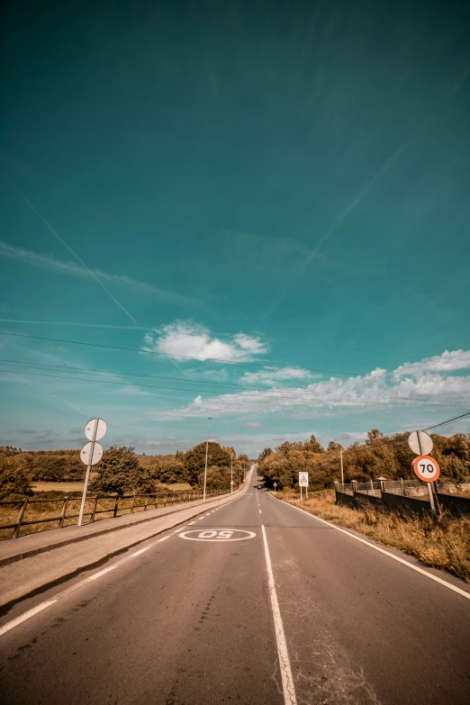 an empty road with a no parking sign