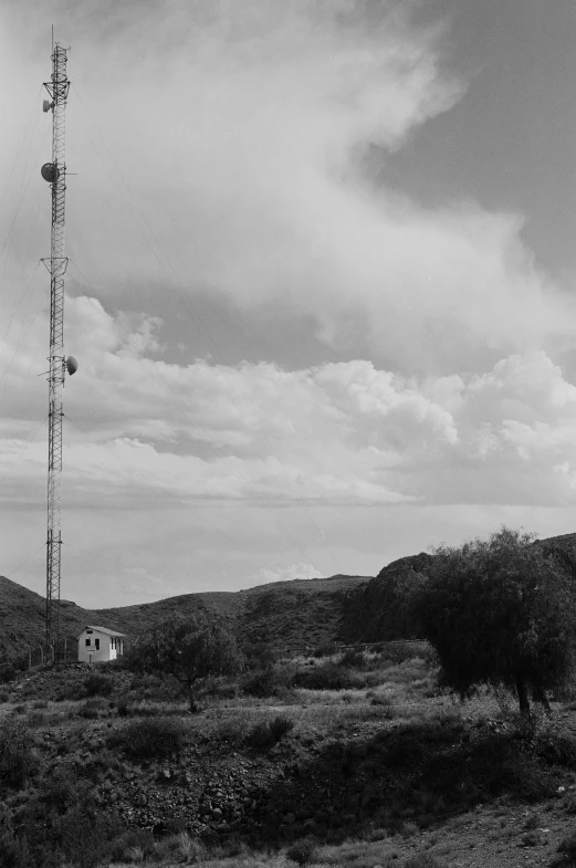 a radio antenna in an open land near a house