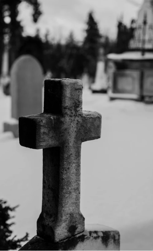 a stone cross standing in front of a church