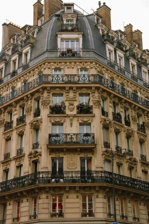 a large beige building sitting next to a blue street sign