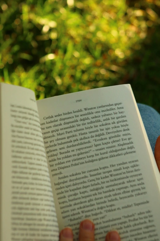 a person holding an open book in their hands