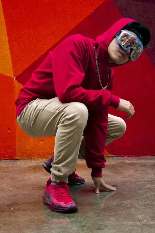 a man standing in front of a wall wearing a mask