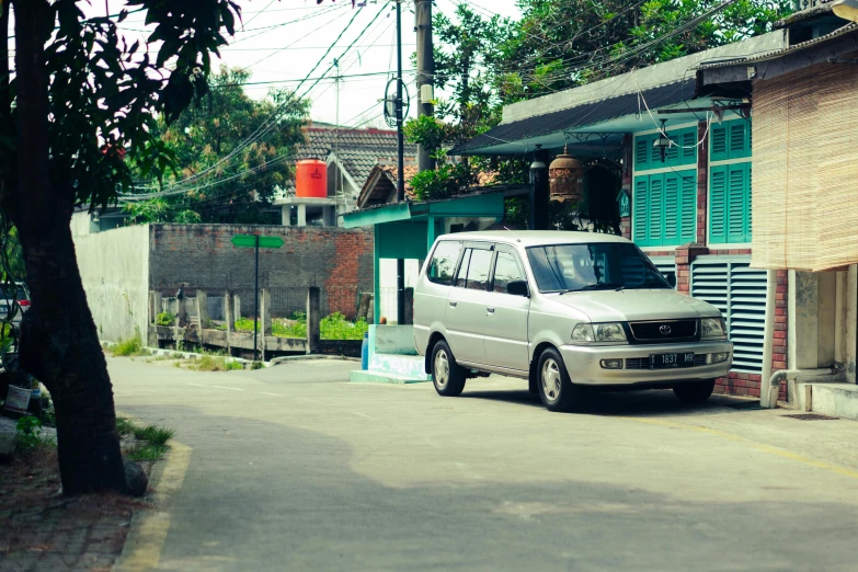 a van is parked in front of a building on the street