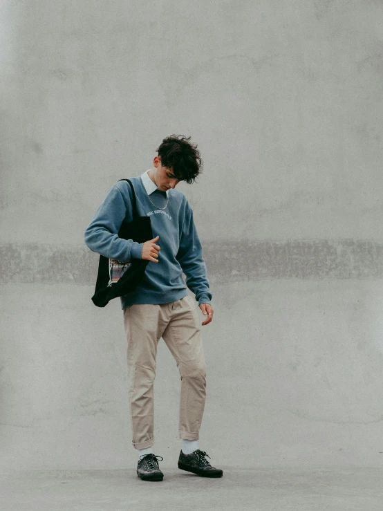 man in blue sweater with black back pack