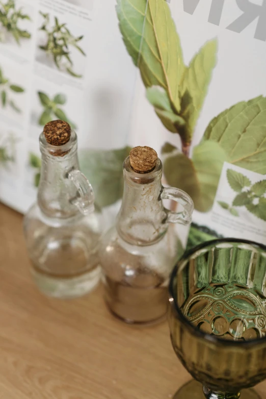 two empty bottles and a small vase on a table