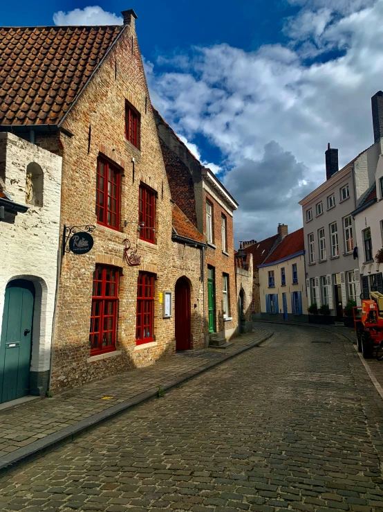 a cobblestone street has many colorful buildings