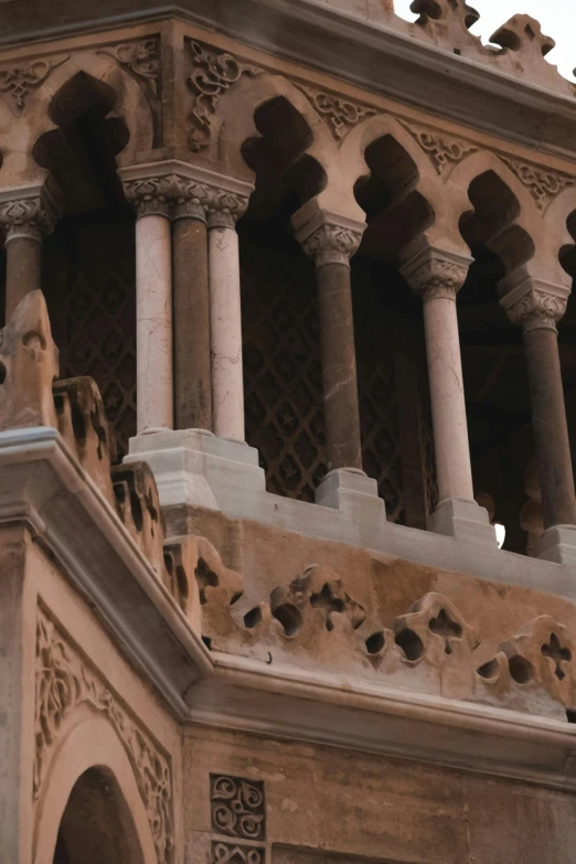 a decorative building is shown with pillars and arches