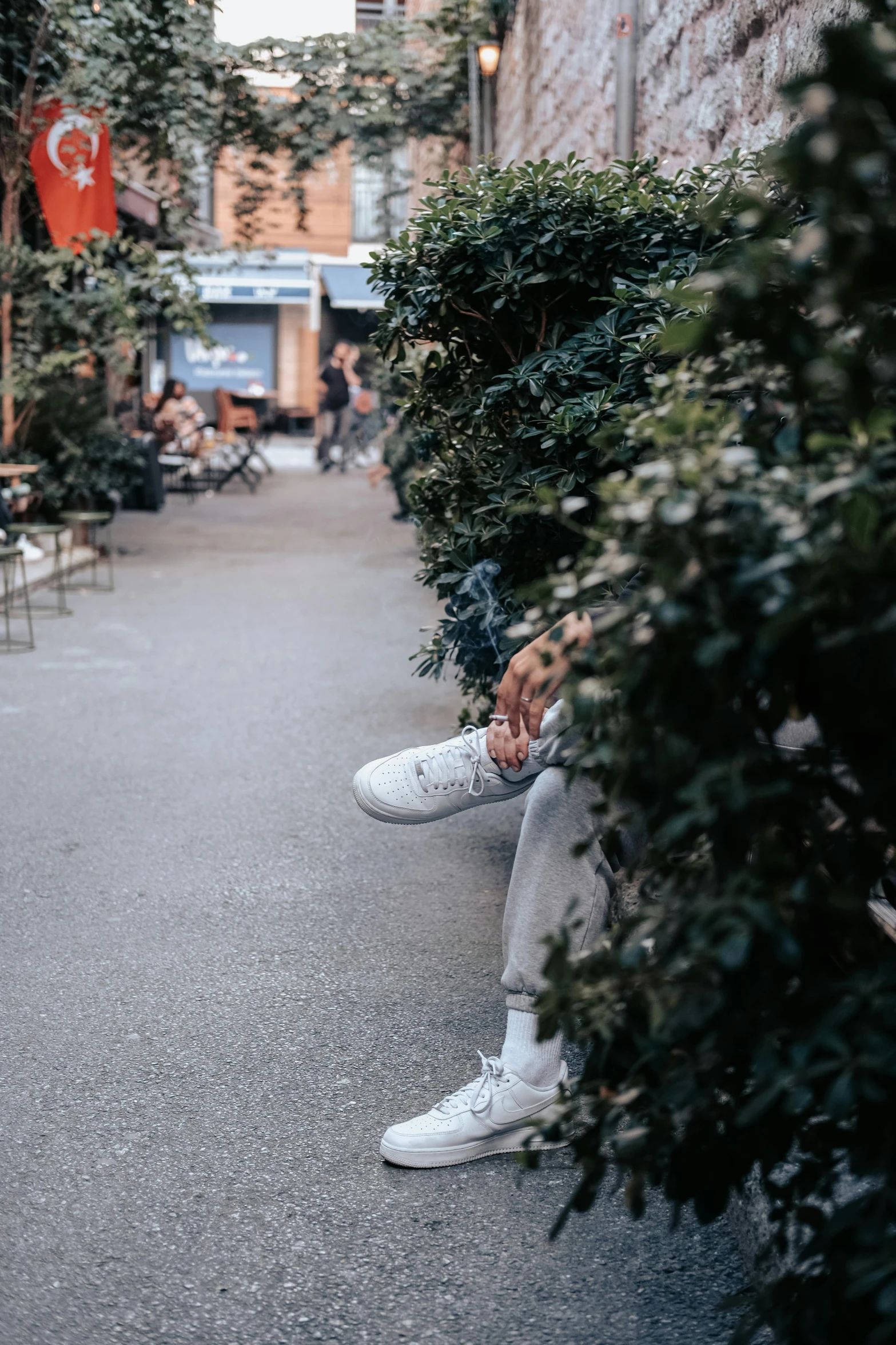 a woman is sitting on the ground in the street