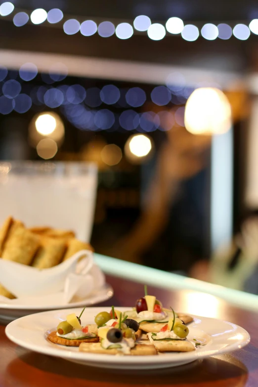 two plates with food, some silverware, a wine glass and a wine glass