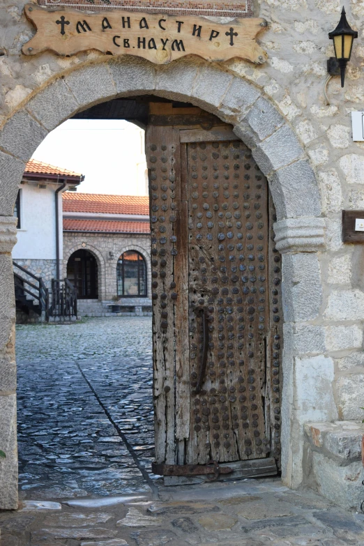 a doorway leading to an old building with a sign on it