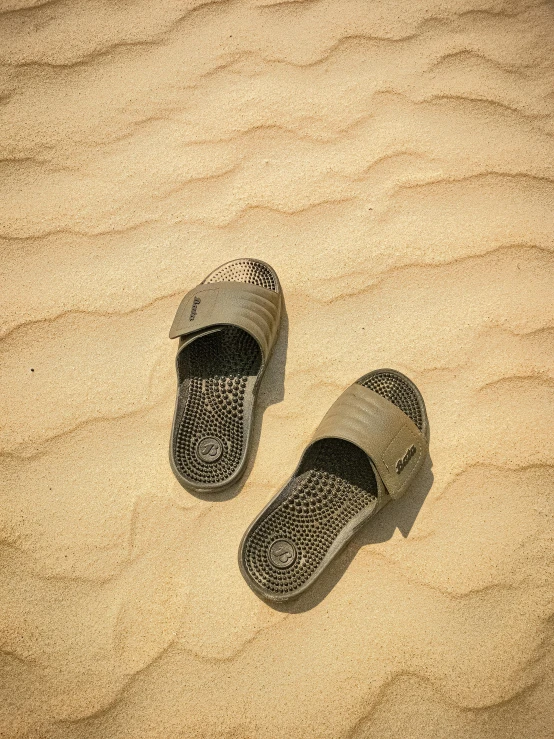 a pair of shoes on the sand in the dunes