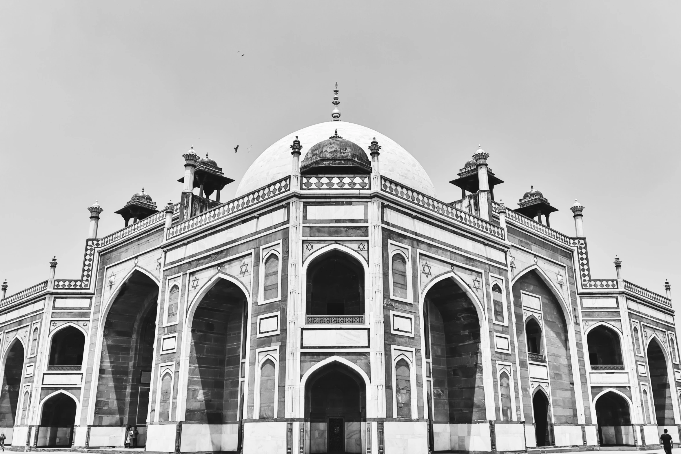 the beautiful building is near the water with statues