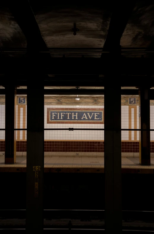 an empty train station with two doors and the sign for fifth avenue