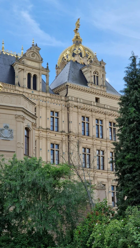 a building with trees and bushes around it