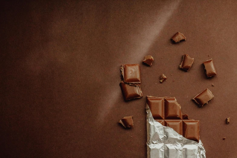 chocolate bars are being cut and set on tin foil