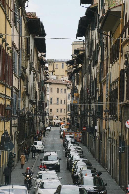 many cars parked in multiple rows of buildings