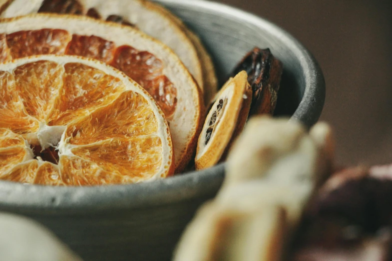 an orange sliced in half sits inside of a bowl