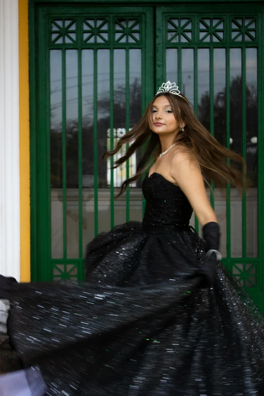 a woman is walking down a city street with her dress blowing in the wind