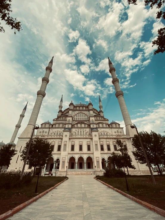 a large building with two tall structures sitting in front of it