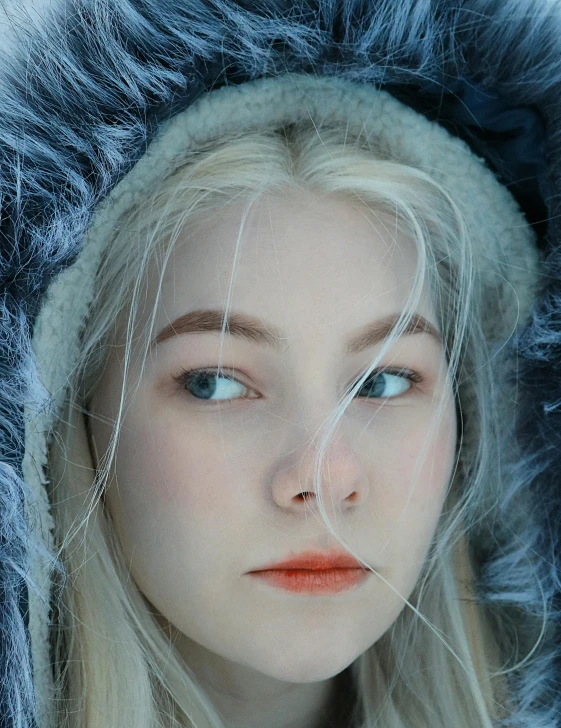 a young woman with a long blonde hair and an over sized fur coat