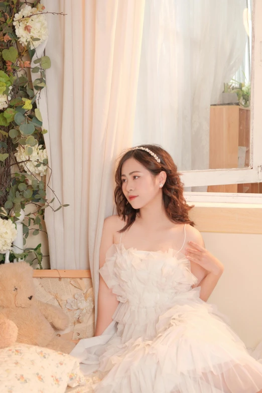 a girl sitting in a white wedding gown