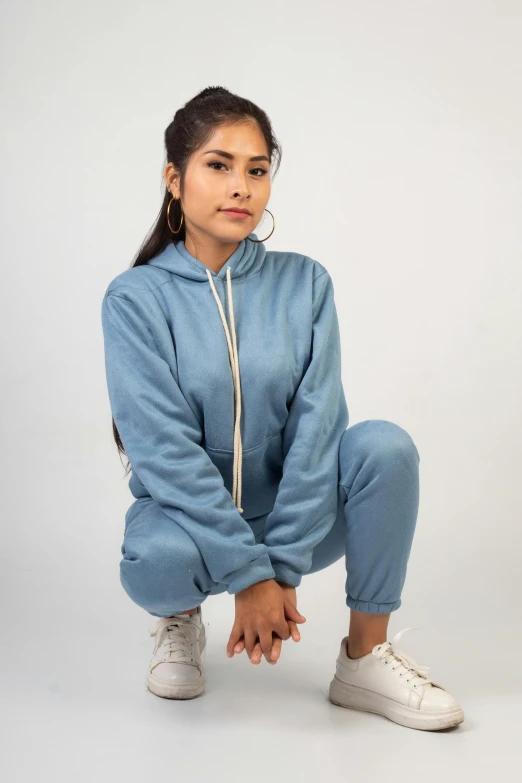 a woman in a denim outfit poses with her foot up