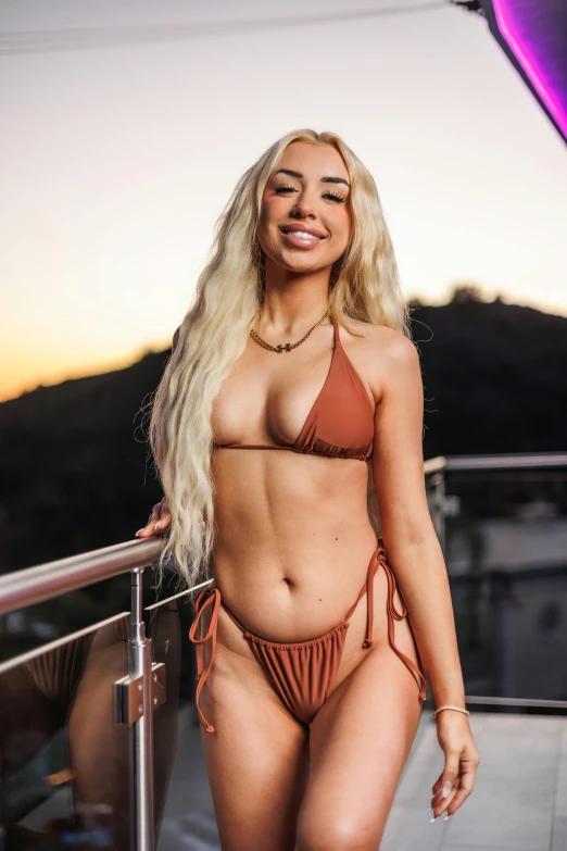 an attractive woman wearing a bikini posing for a po