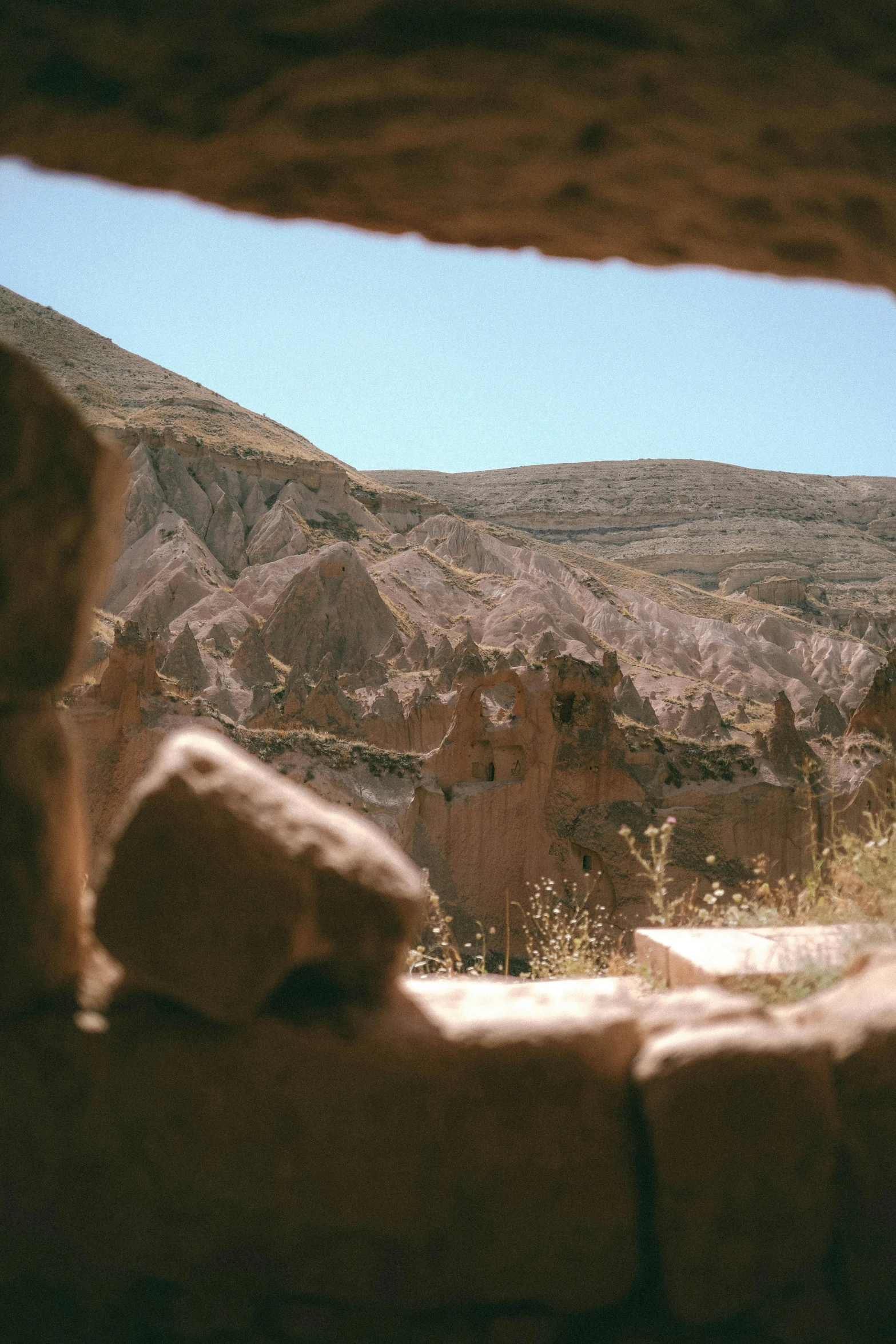 a window looking out onto the mountains with rocks