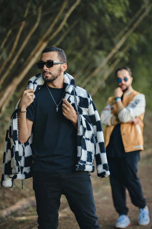 two men who are standing with some clothes on