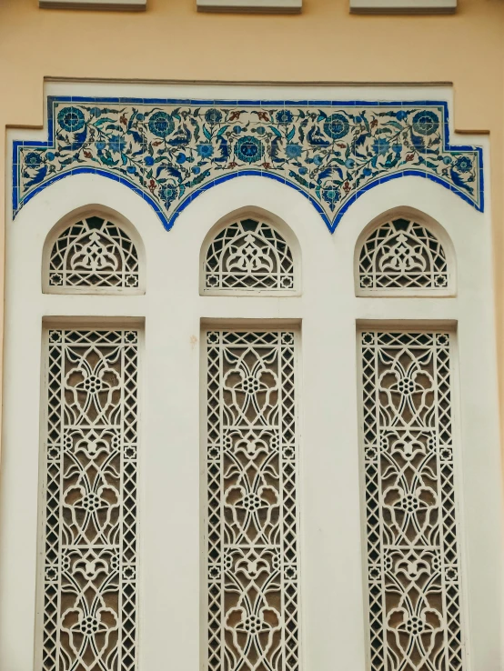 the windows and sides of a building are painted with intricate designs