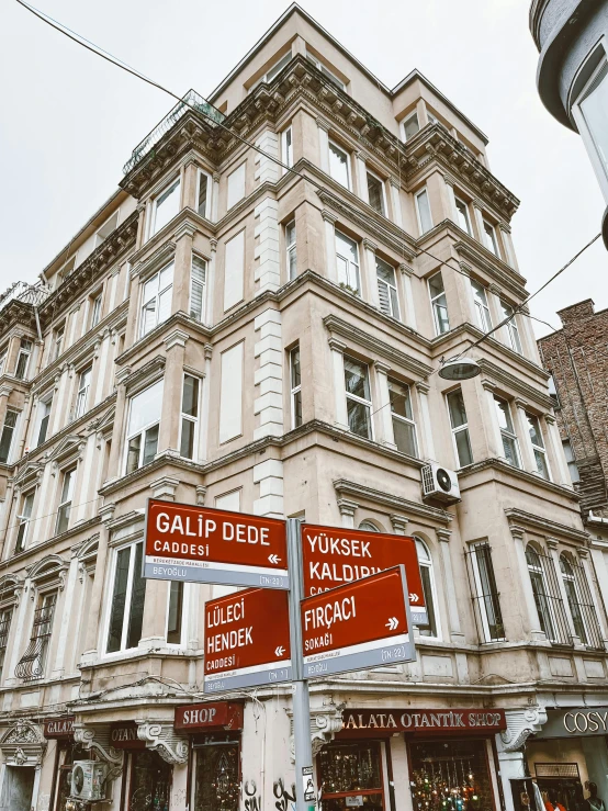 a couple of red street signs sitting on the corner of a road