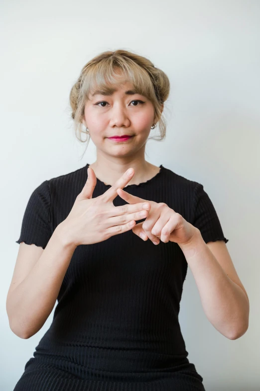 a woman that is sitting down and making a gesture