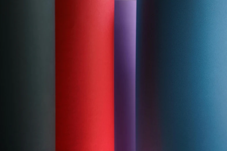 a close up of four different colors of paper