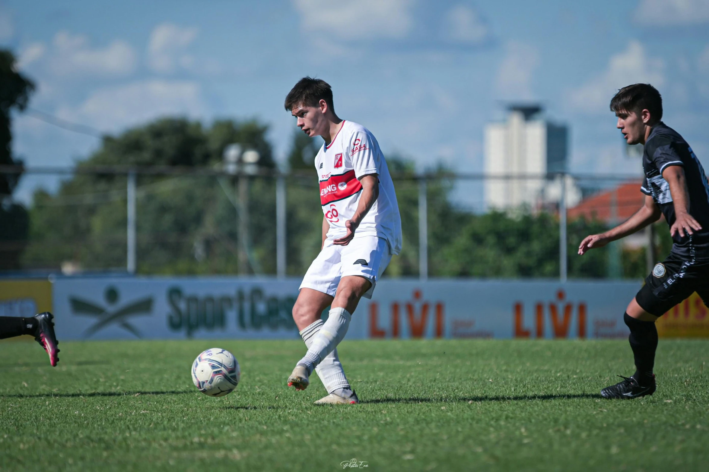 two guys are playing soccer on a field