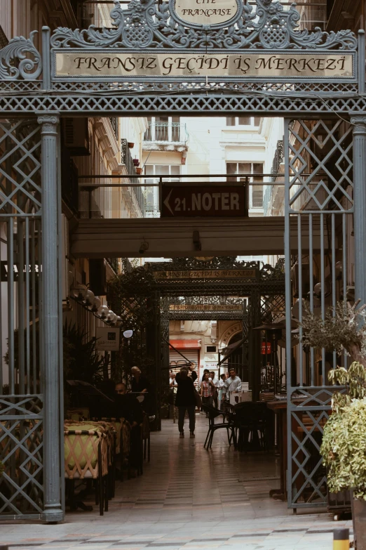 a group of people walk through a covered entrance into an office