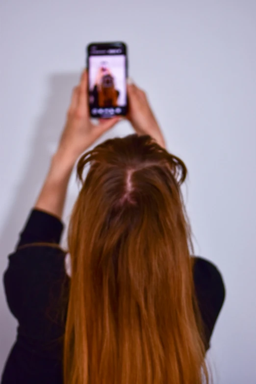 a woman taking a selfie with her phone