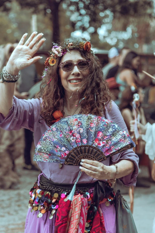 woman wearing large floral headpiece holding umbrella