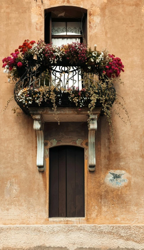 an old building with flowers hanging off the window