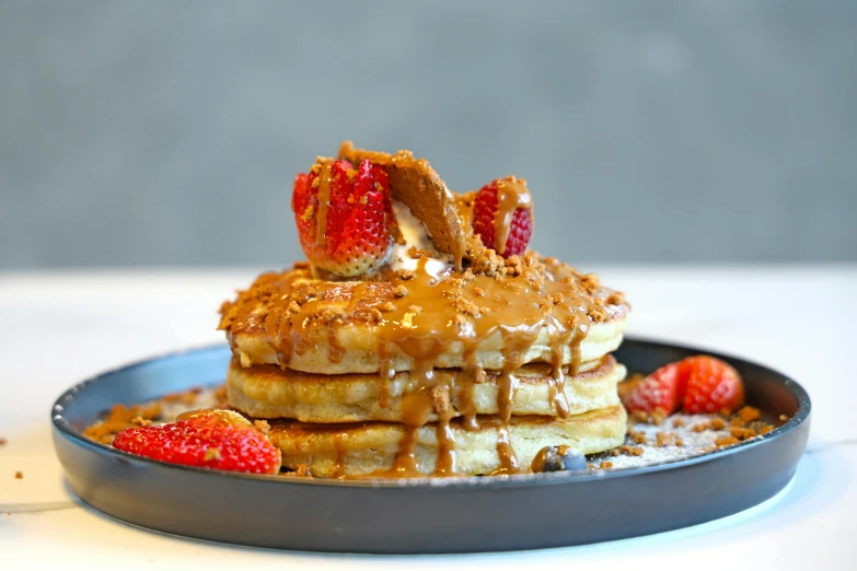 a stack of pancakes with strawberries on top