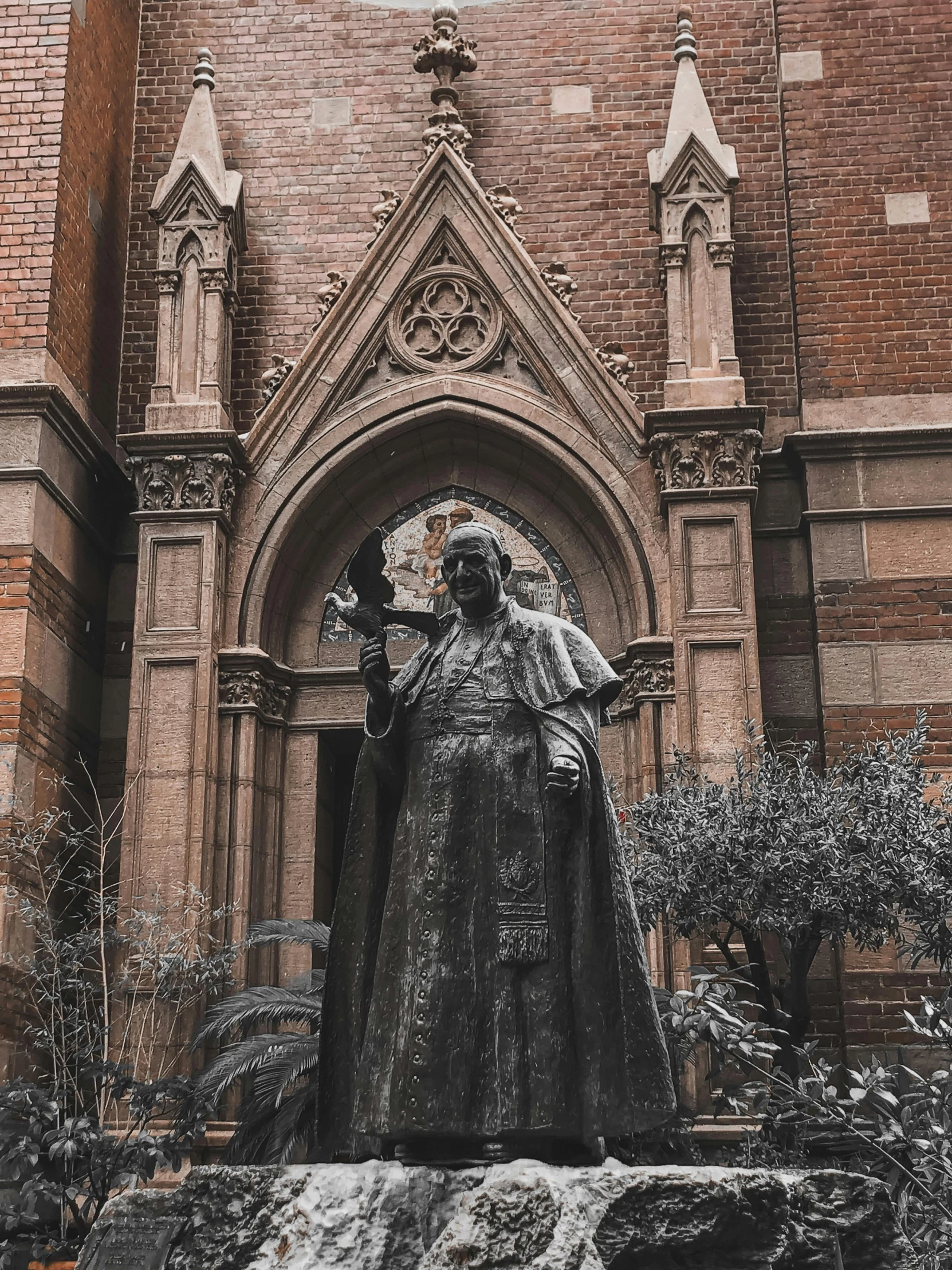 a statue is shown in front of a church