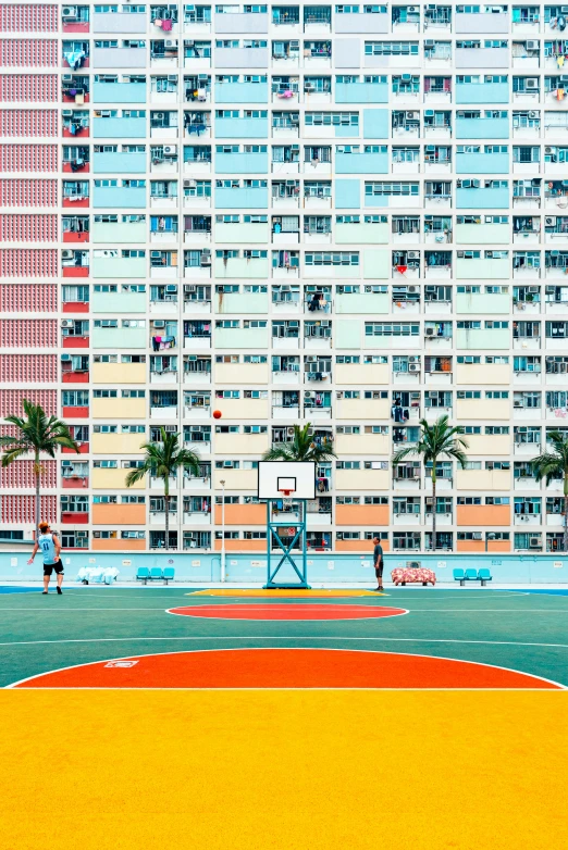 basketball court and apartment buildings in tropical setting