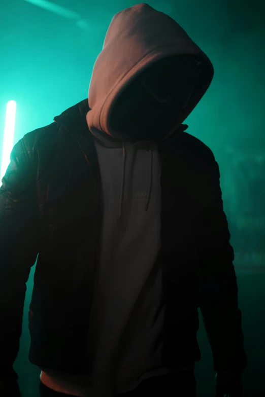 man wearing hoodie with a flashlight glowing through back