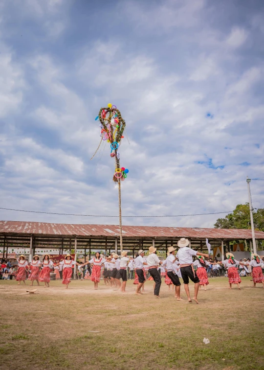 the children are dressed in white and have their own group of people in red and black clothing