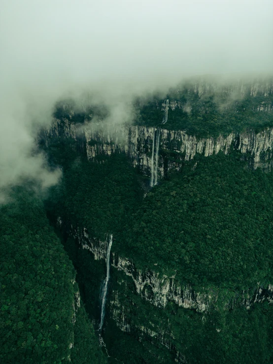 two cliffs with a few clouds on top