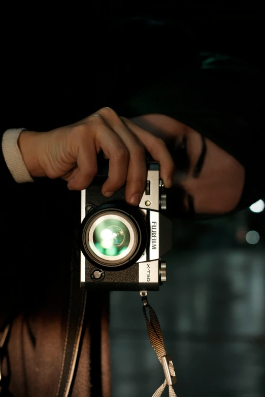 a person holding onto a small camera to take a po